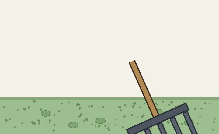 A two-handled broadfork resting on loosened garden soil